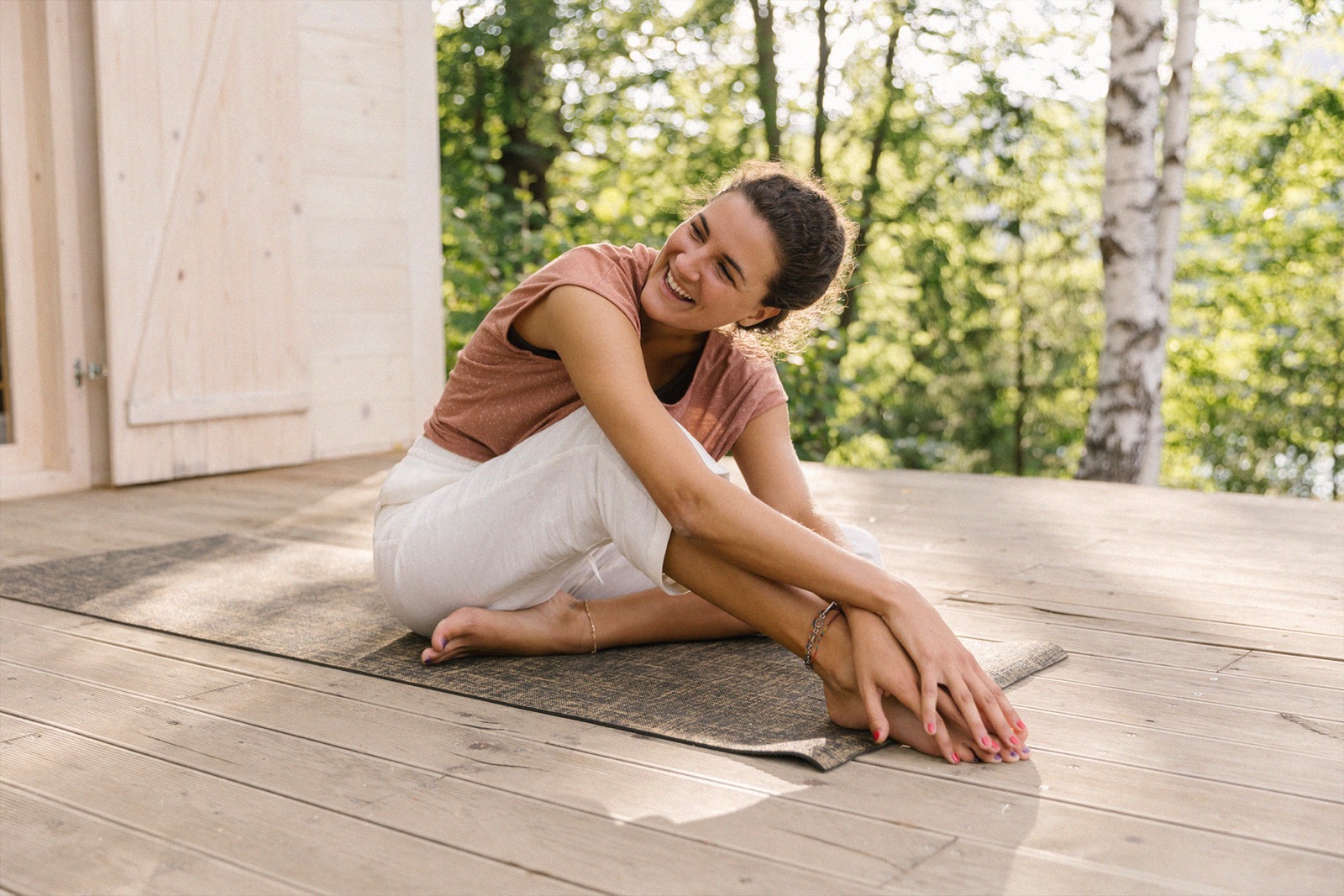 A patient stretching on a sunlit deck